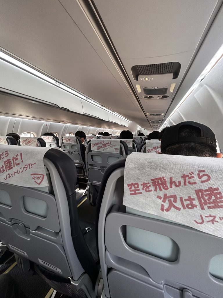 トキエアの機内。通路をはさんで2席ずつ座席が並び、ヘッドレストに白いカバーがかかっている