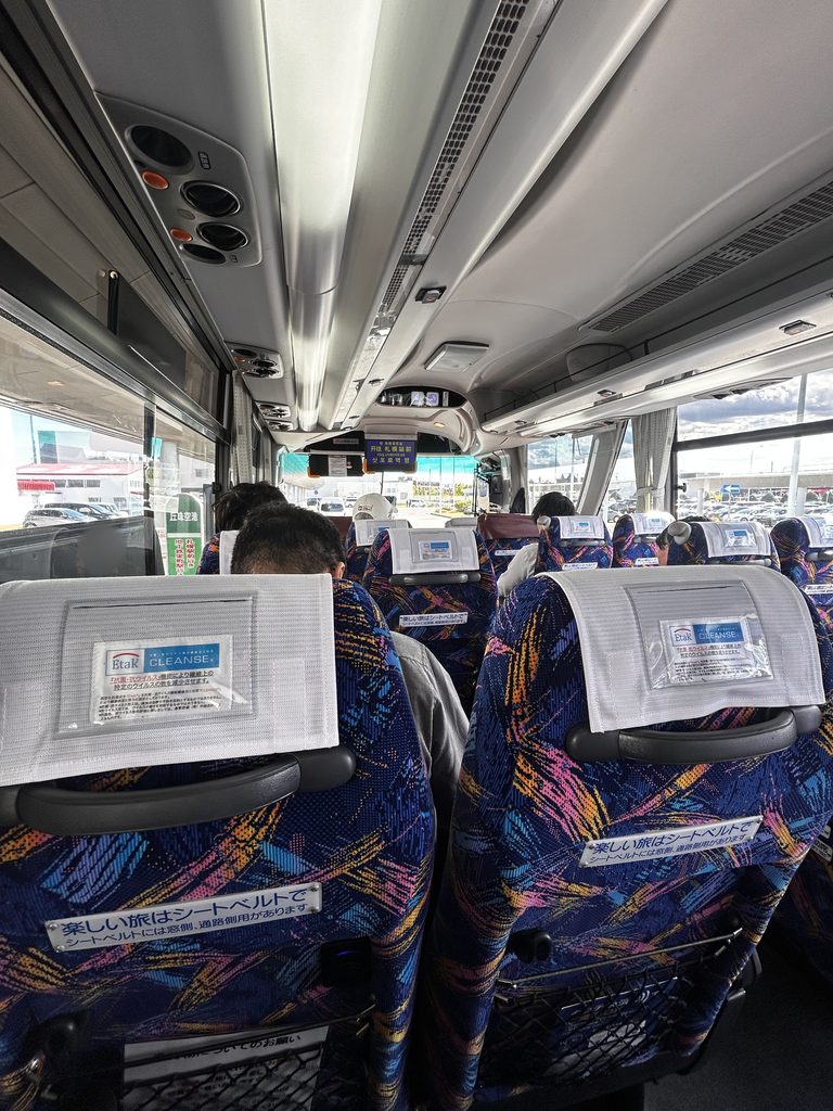 空港連絡バスの車内。カラフルな柄の座席が並ぶ